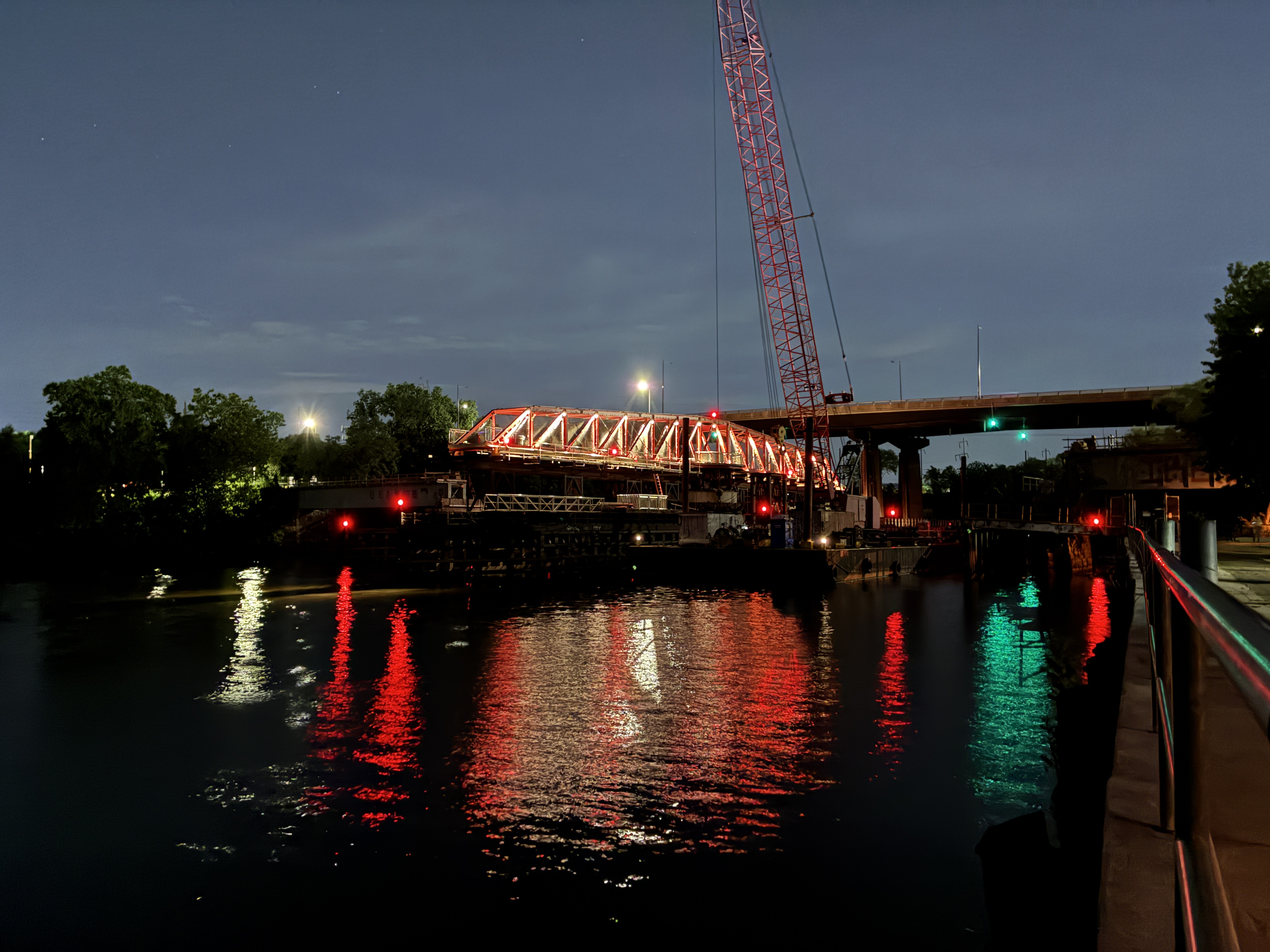 Schuylkill Crossing bridge lit up with red and white at night