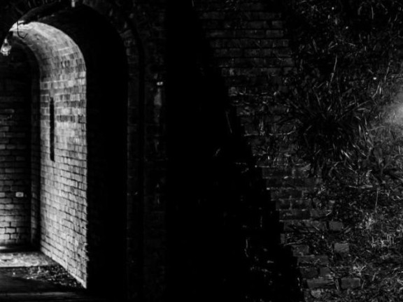 door lit up in in a darkened room that also features a ghostlight