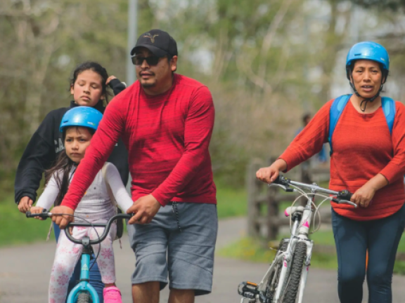 A family out with two bikes at Bartram's Mile