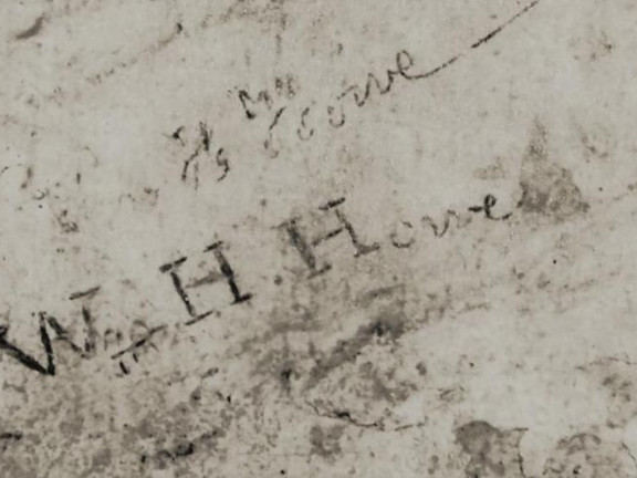 inscription of the name W H Howe in stone