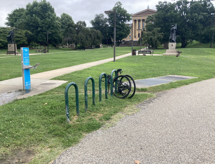 Bicycle rack behind the Philadelphia Museum of Art, situated between the paved trail and a slope up to the museum.