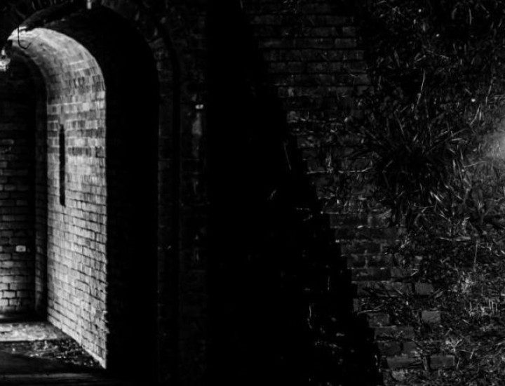 door lit up in in a darkened room that also features a ghostlight