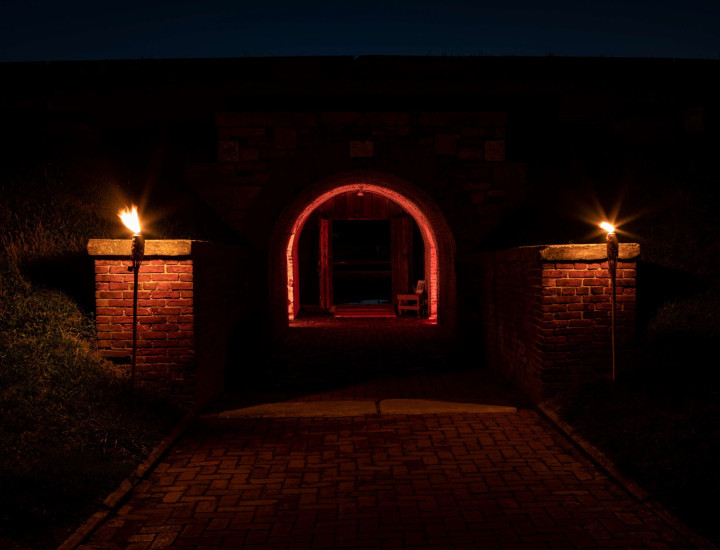 Image of Fort Mifflin eerily lit up by orange lights