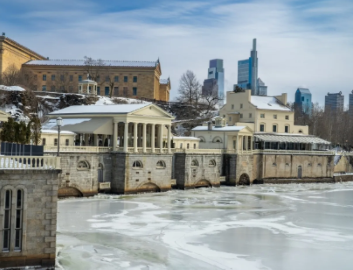 Image of Fairmount Water Works in winter with the frozen Schuylkill River in the foreground
