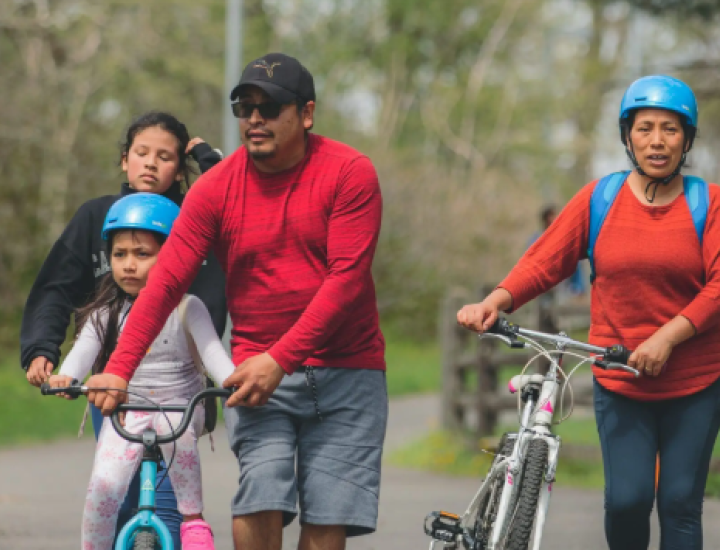A family out with two bikes at Bartram's Mile