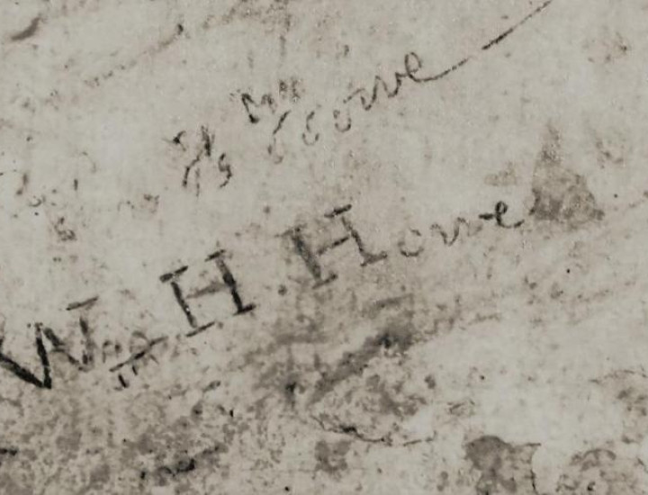 inscription of the name W H Howe in stone